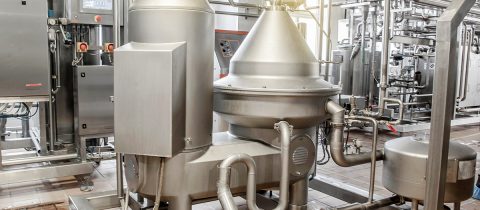 Installation for pasteurization of milk at a dairy plant. Brilliant stainless steel pipes. Abstract industrial background