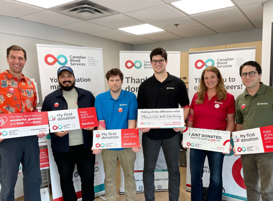 Group of donors posing with signage