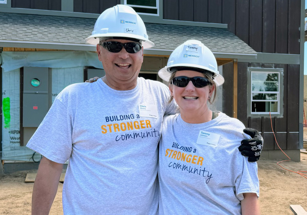 Two volunteers in hard hats on a work site